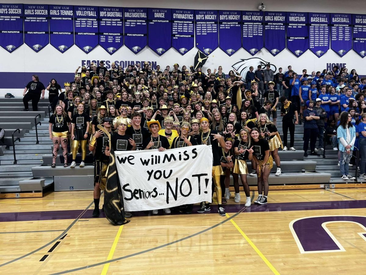 The Senior class poses for a picture with the Junior classes flag