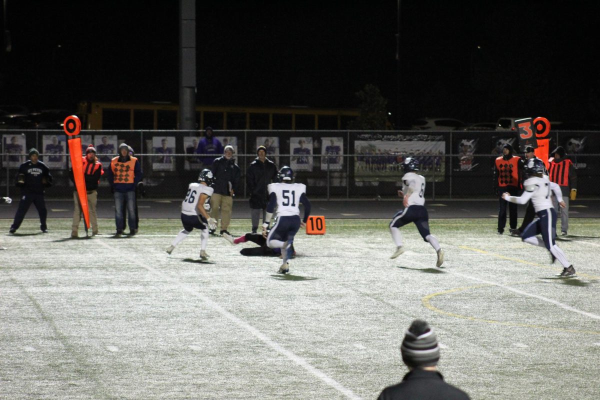 Ayden Jensen sliding short of first down in game against Saint Peter for cancer night.