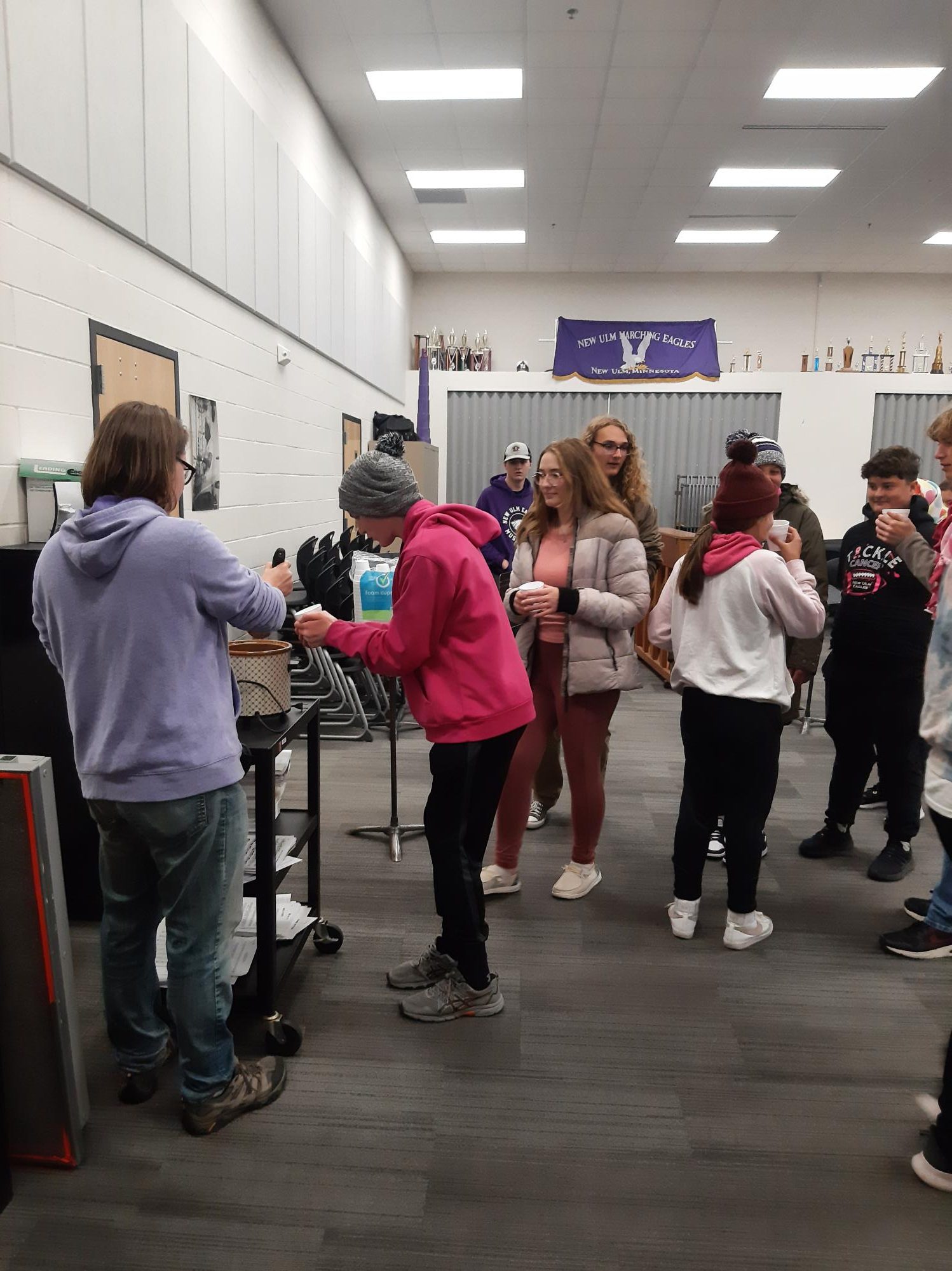 Band members warming up with some cider after performing at the football game.