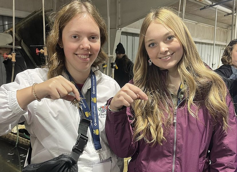 Juniors, Megan Berenek (left) and Madilyn Portner holding crawfish at Ozark Fisheries in Martinsville, Indiana. 