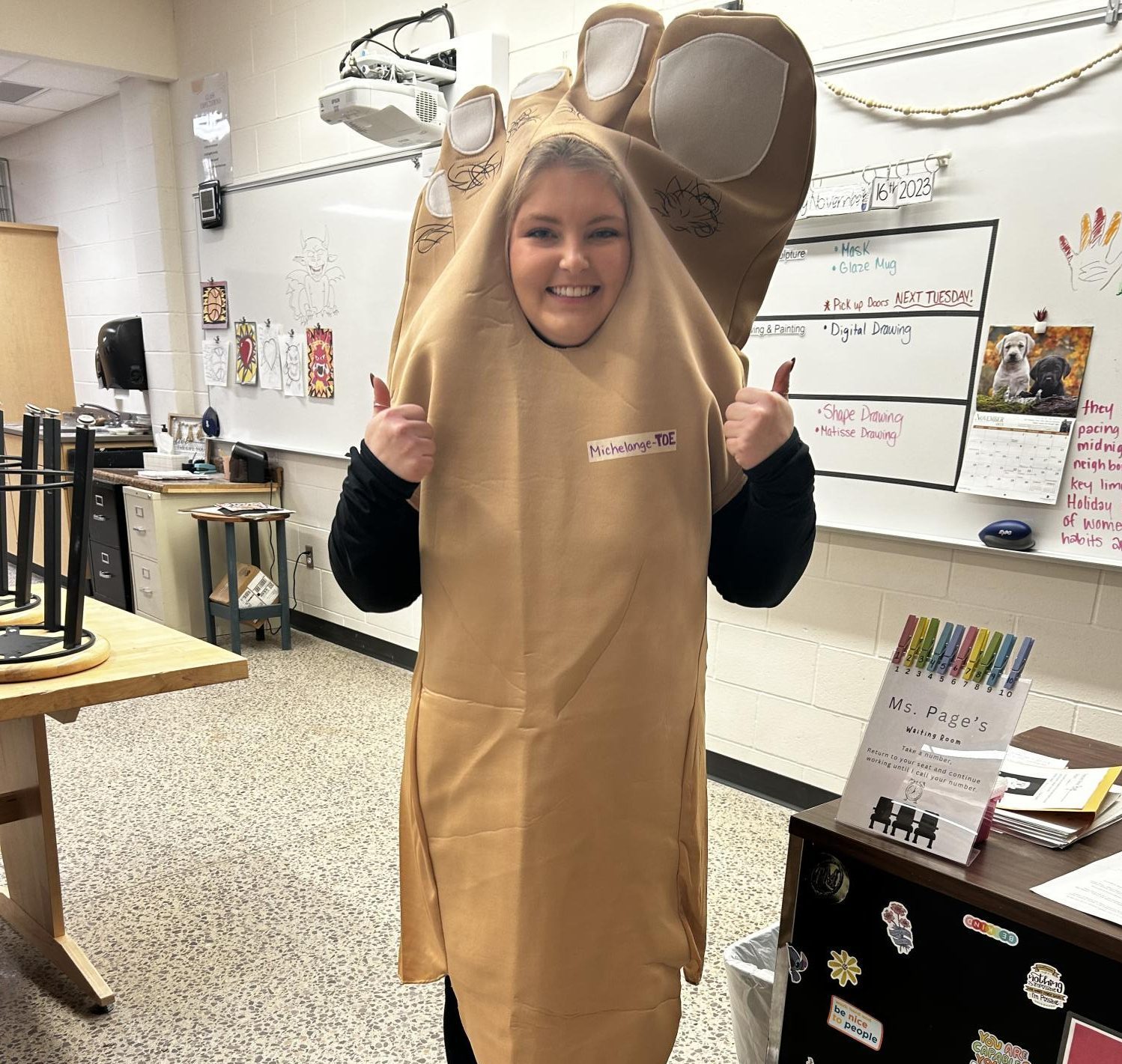 Ms. Page poses in her foot costume after winning the Student Council's food bank donation drive.