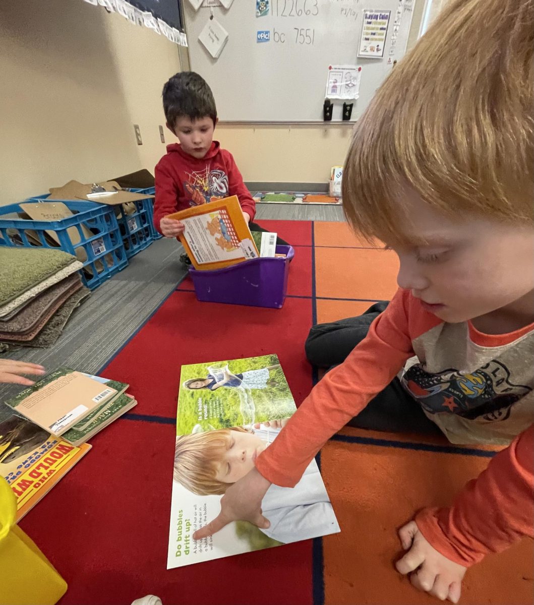 1st-grade student Axton silently reading in his head.