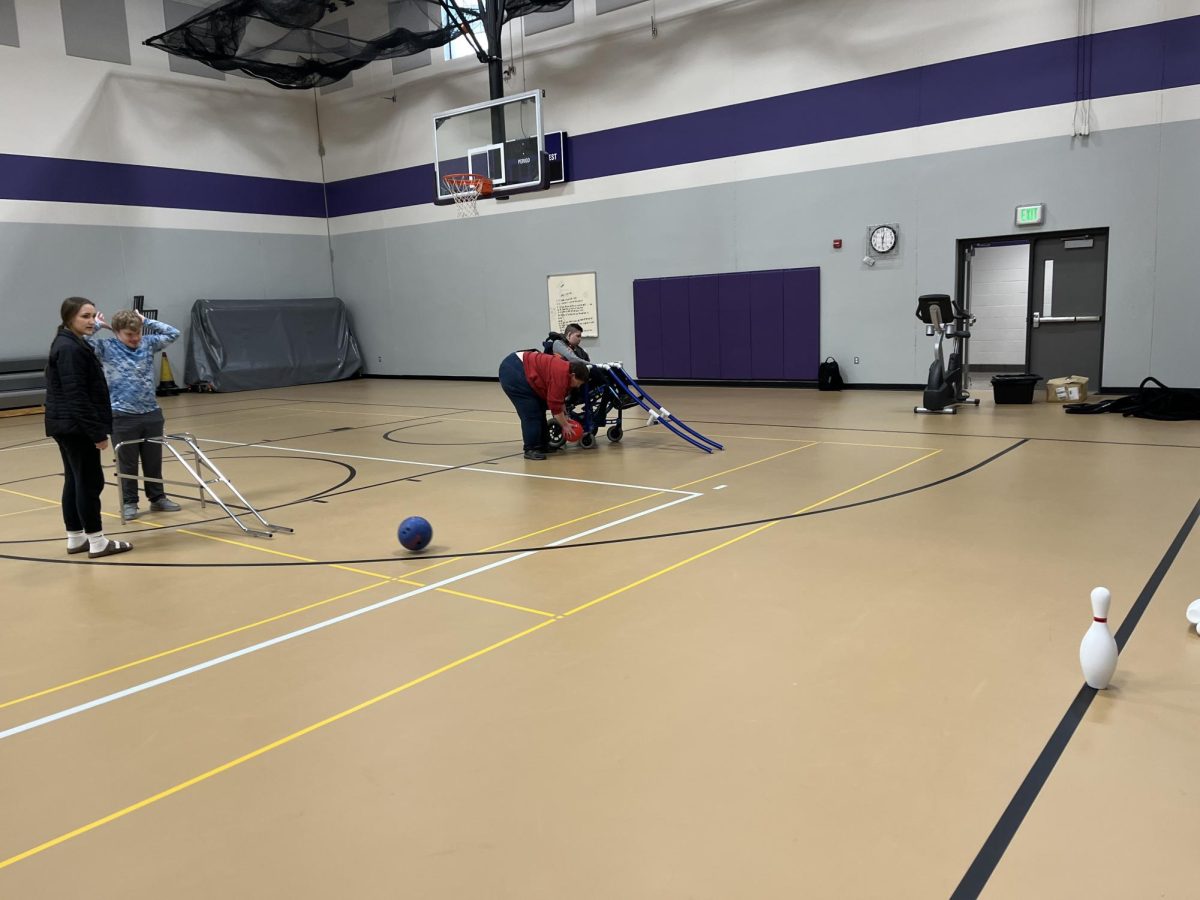 Junior Bryce Braulick rolls the bowling ball at the pins 