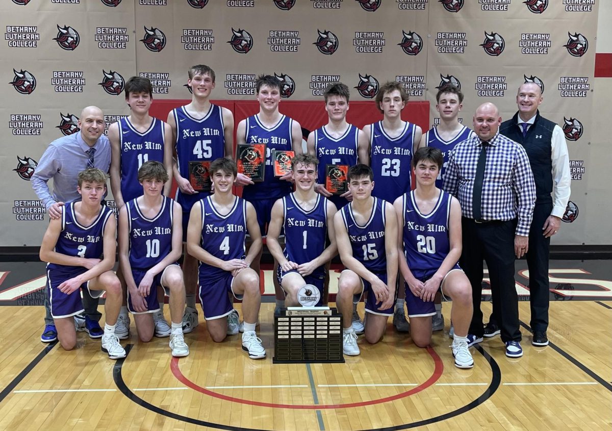 The Eagles boys basketball team poses for a picture with awards/trophy after winning the Kwik Trip holiday tournament.