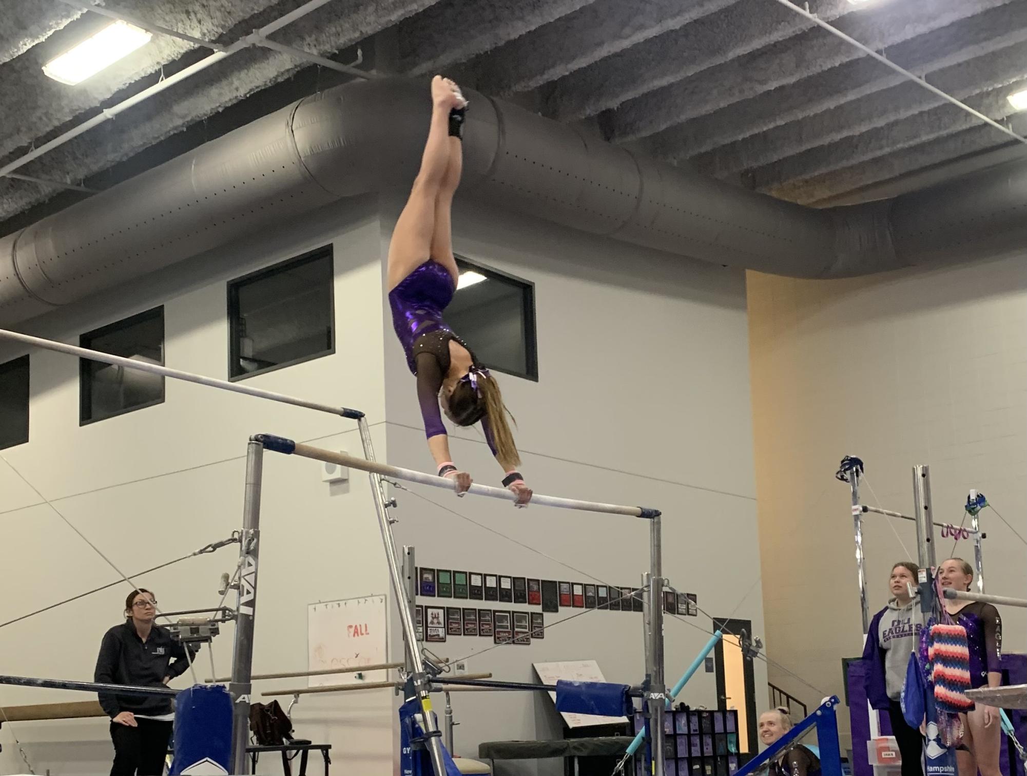 Pictured is Joelle Haala on Senior Night hitting her handstand on bars.