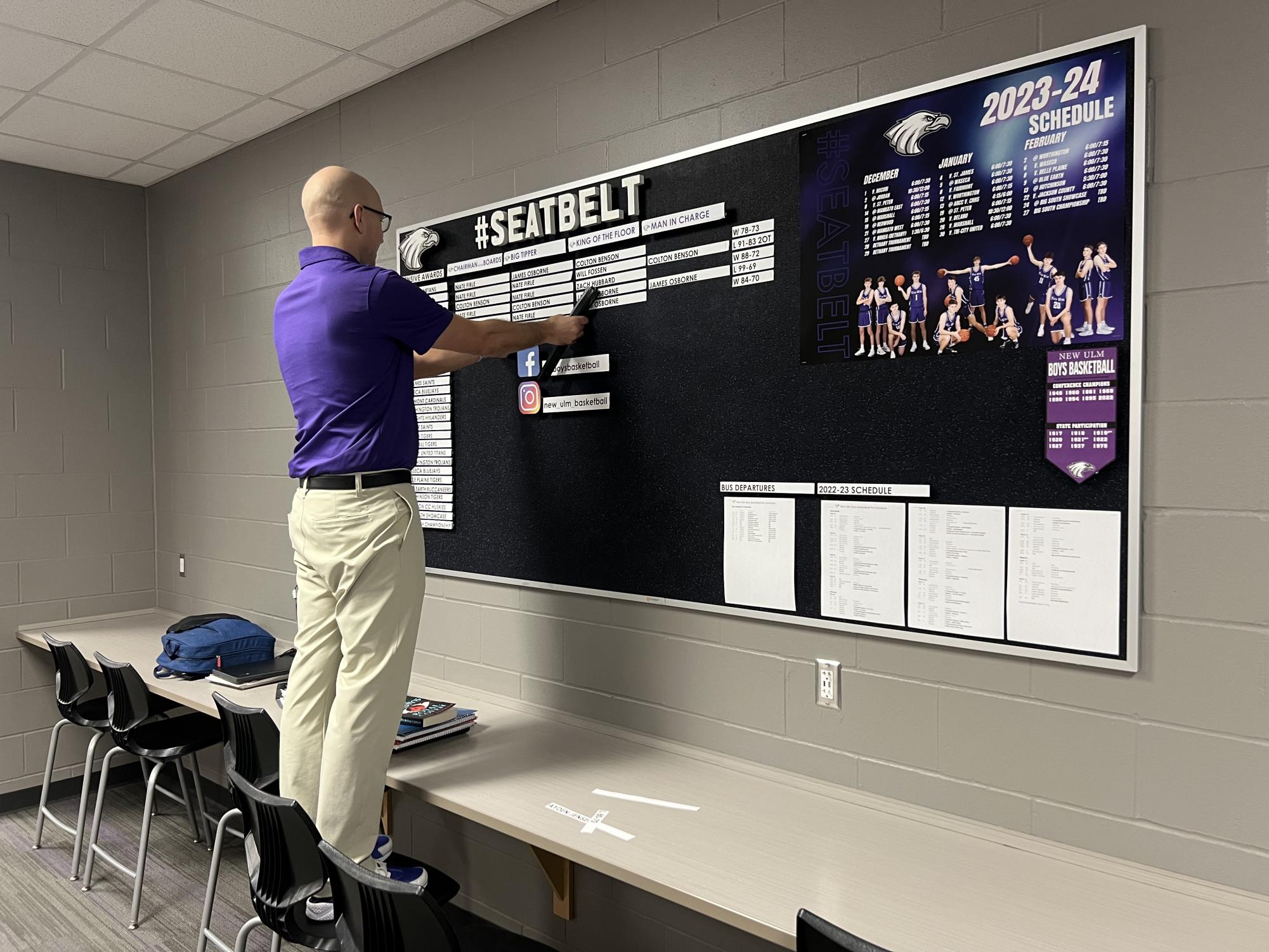 Coach Dennis hanging up the "game awards" from a past game this week. Little things he focuses on are rebounds, deflections, getting on the floor, and charges.