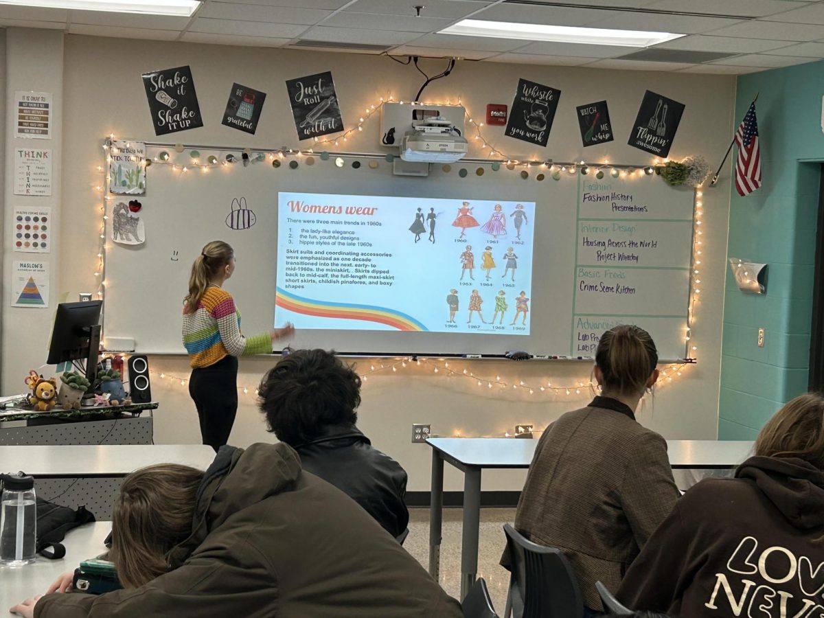 Freshmen Keelie Dietz showing her presentation on 1960s women's fashion trends  