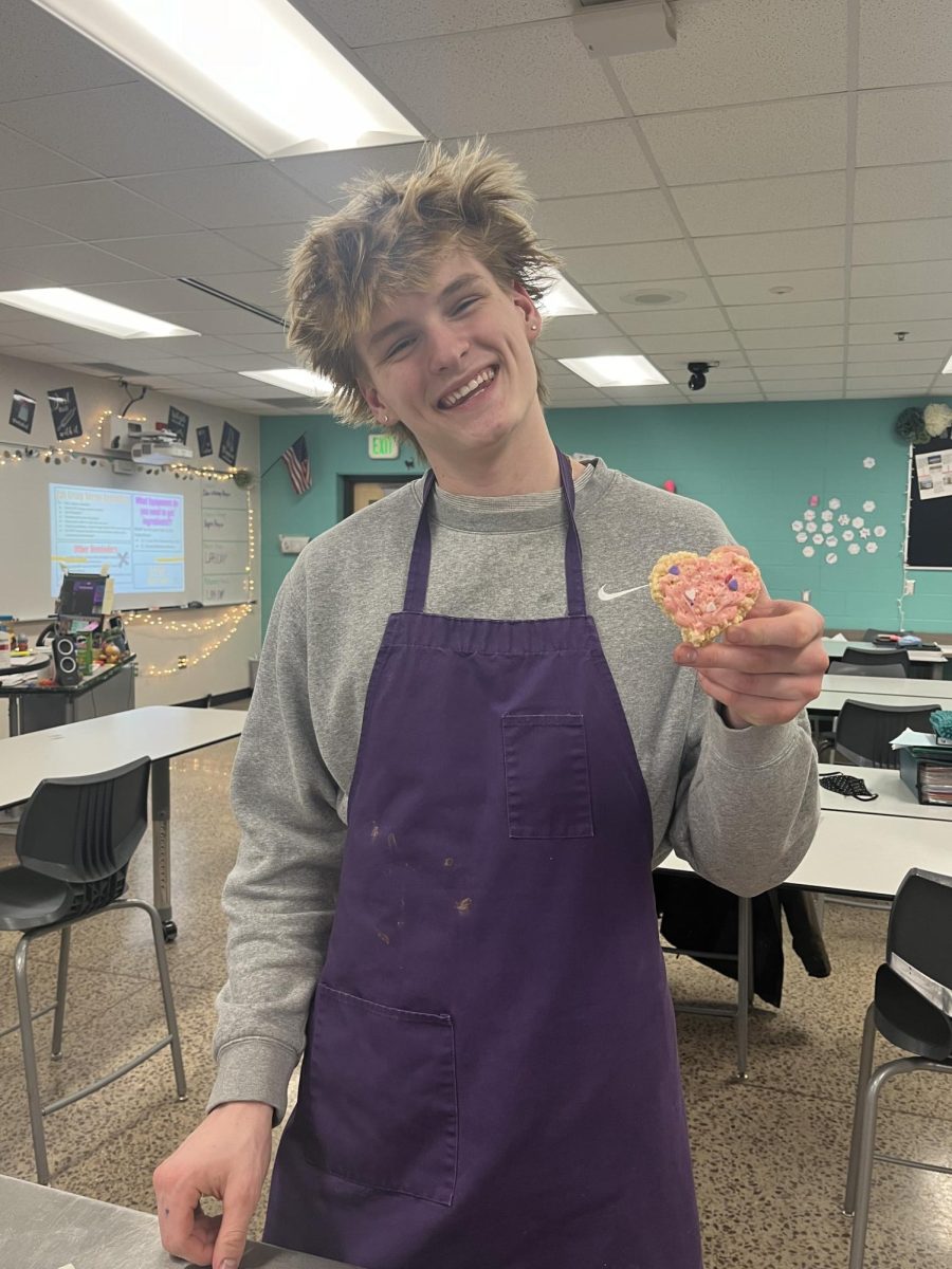 Senior Tallak Rakowski posing with one of the rice krispie treats he made.