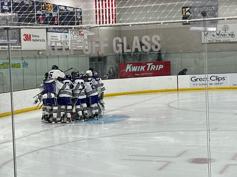 Senior Austin Uecker jumps into the huddle 