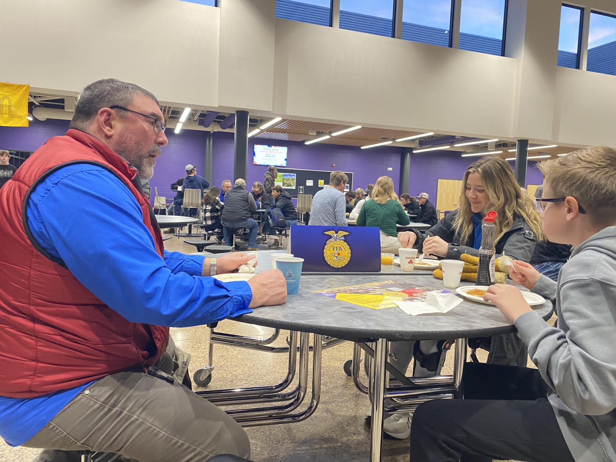 KNUJ personality Tom Wheeler talking it up with senior Daviney Dreckman at the annual FFA pancake breakfast. 