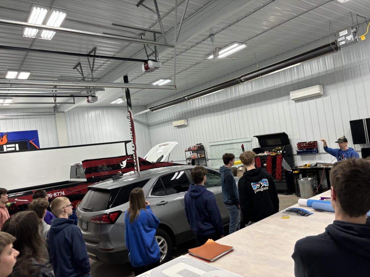 Intro to Business students touring the Fuel Graphics' garage