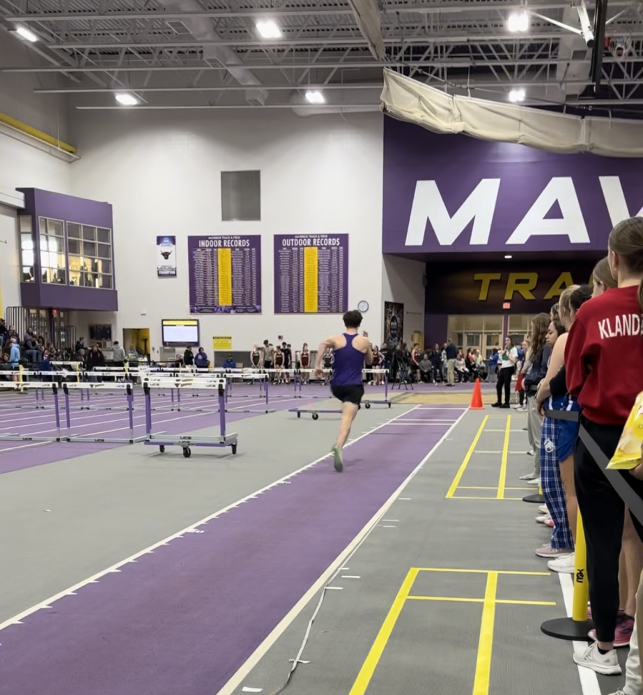 Senior Easton Clark approaching the long jump pit.