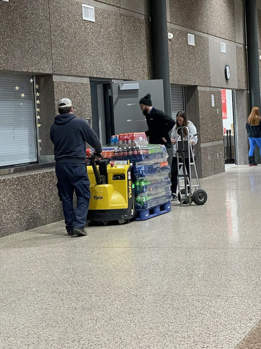 Workers stocking the concession stand during school hours to get ready for up coming events.