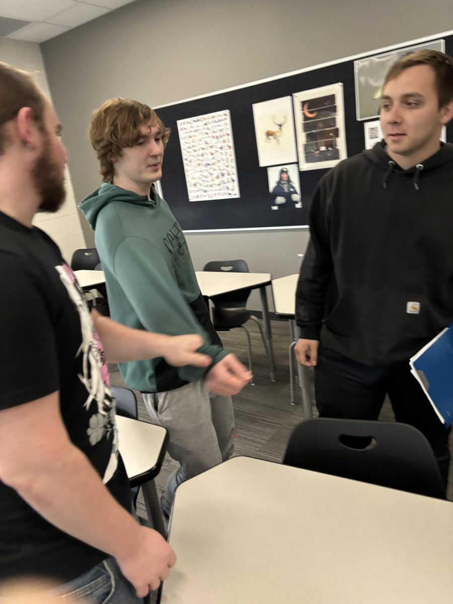 Seniors Brennan Benson, Brody Griebel, and Joseph Haag having an engaging conversation.