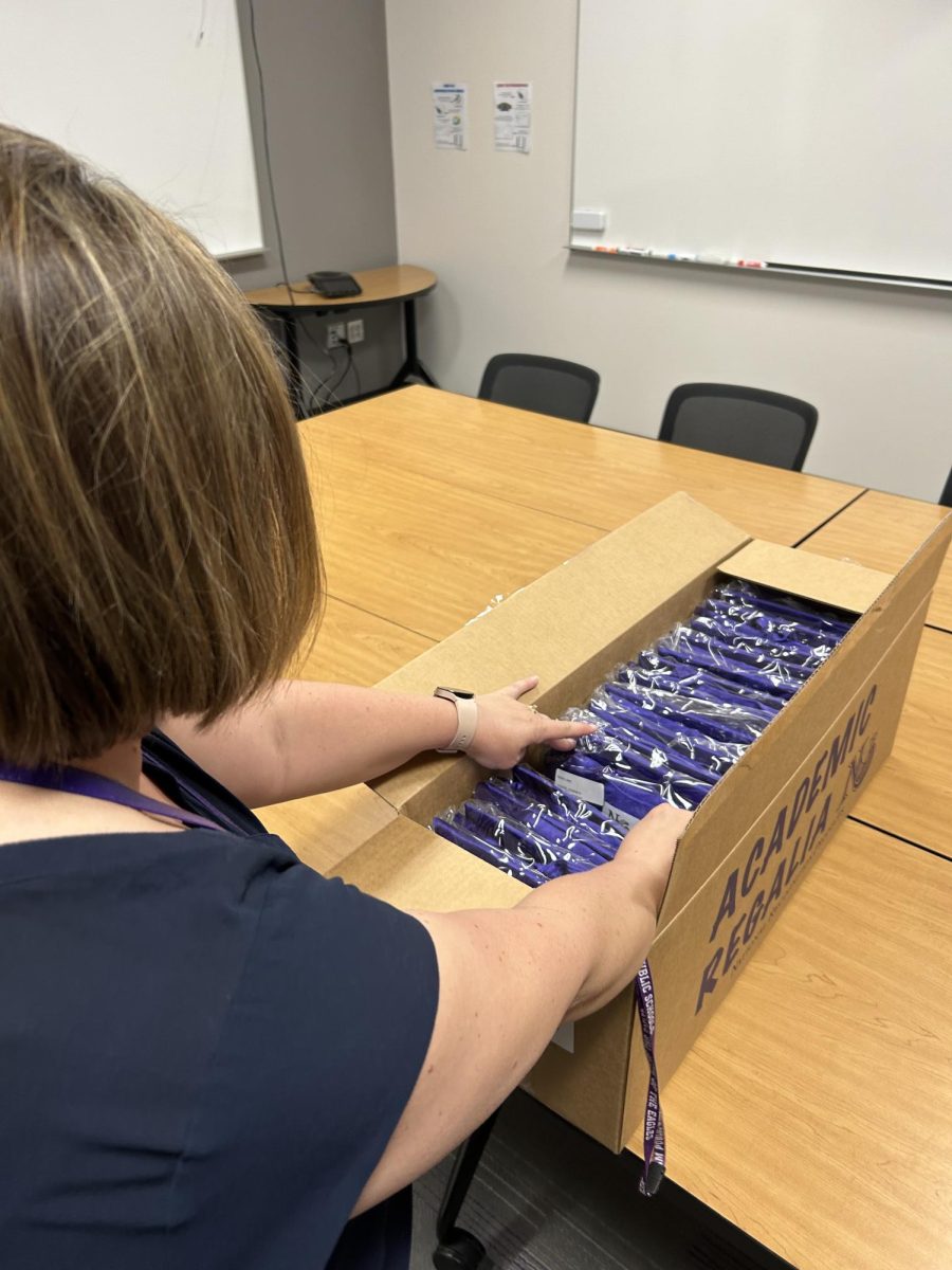 Erin Jensen going through the caps and gowns for the seniors, to make sure they are all there.