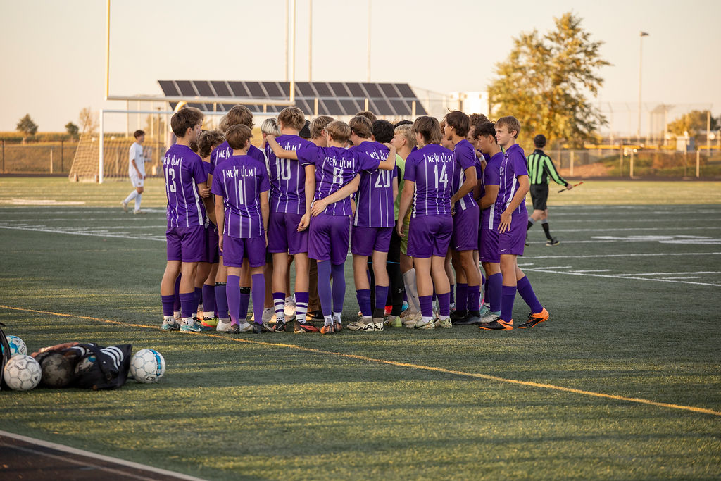 The soccer team getting ready to play against Waseca, the same night where the season record was broken by winning the game 4-1.