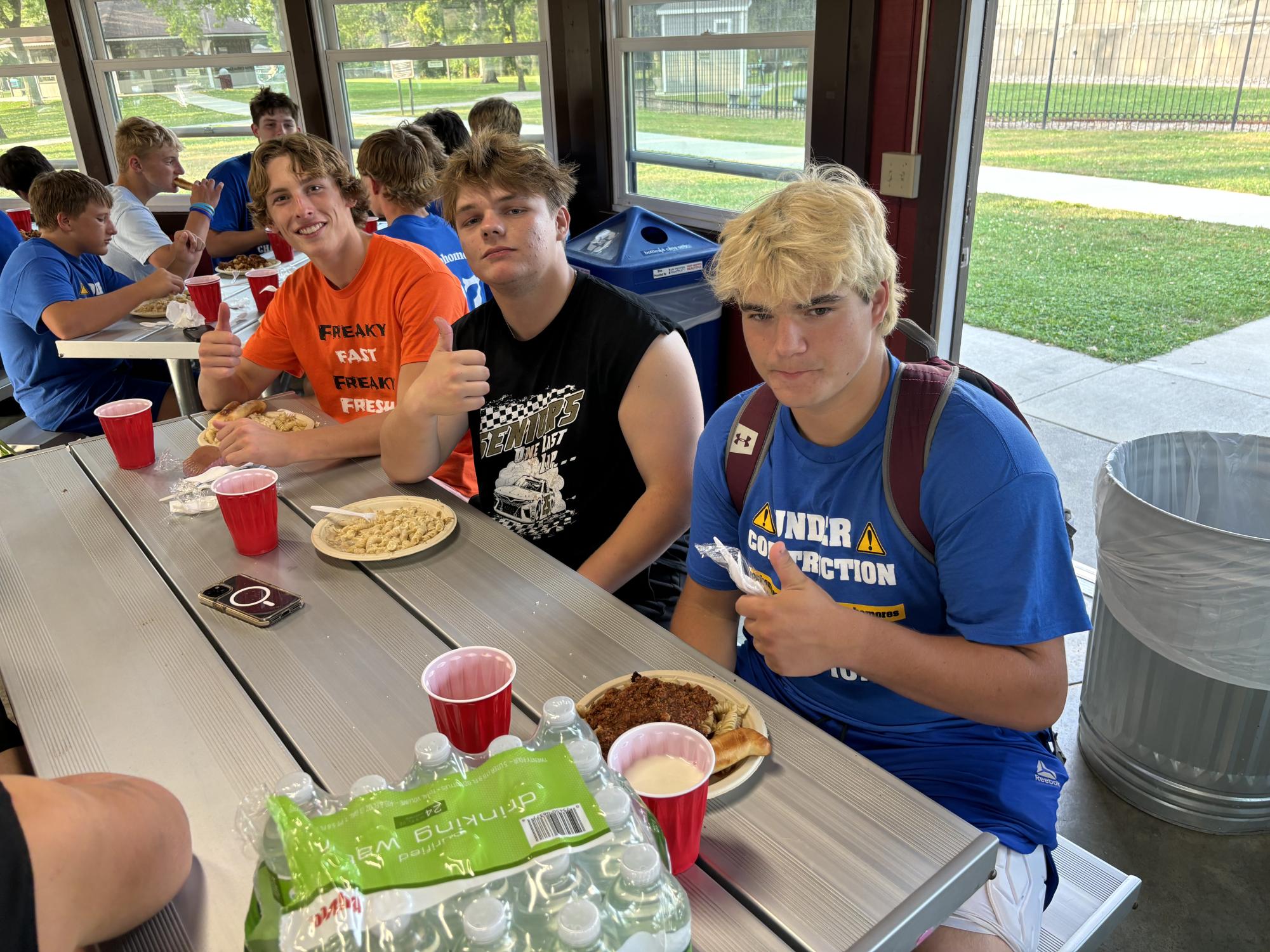 After some intense arm wrestling matches at NUHS's Battle of the Classes, Arm wrestlers (L to R) Owen Castleman, Henry Waloch, and Tanner Backer recover at the pasta feed before the big game on Friday night.