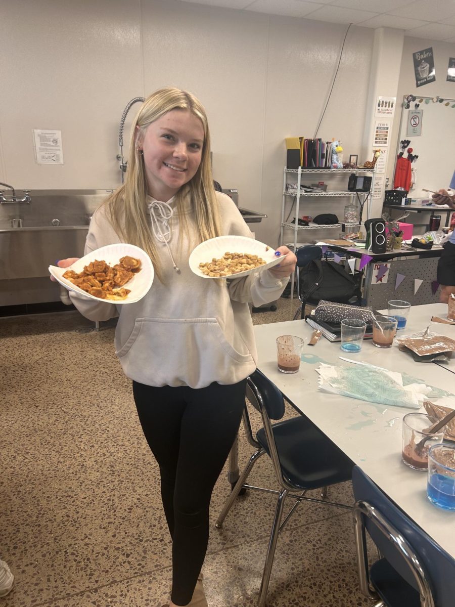 Maddy Wellman poses with her cheese tortilini made from an MRE. 