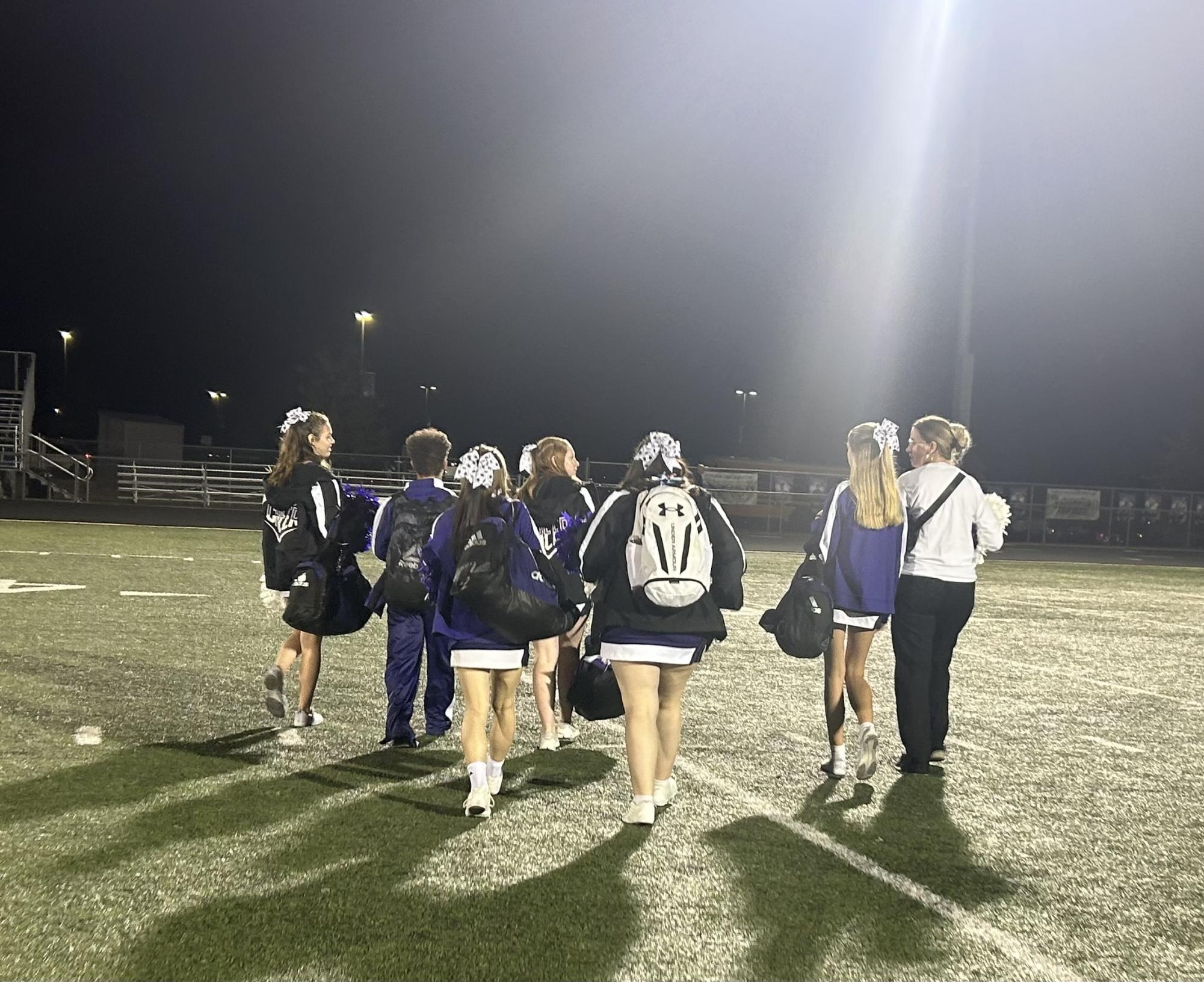 Cheerleaders heading out after exciting night of rallying the team and firing up the fans. 