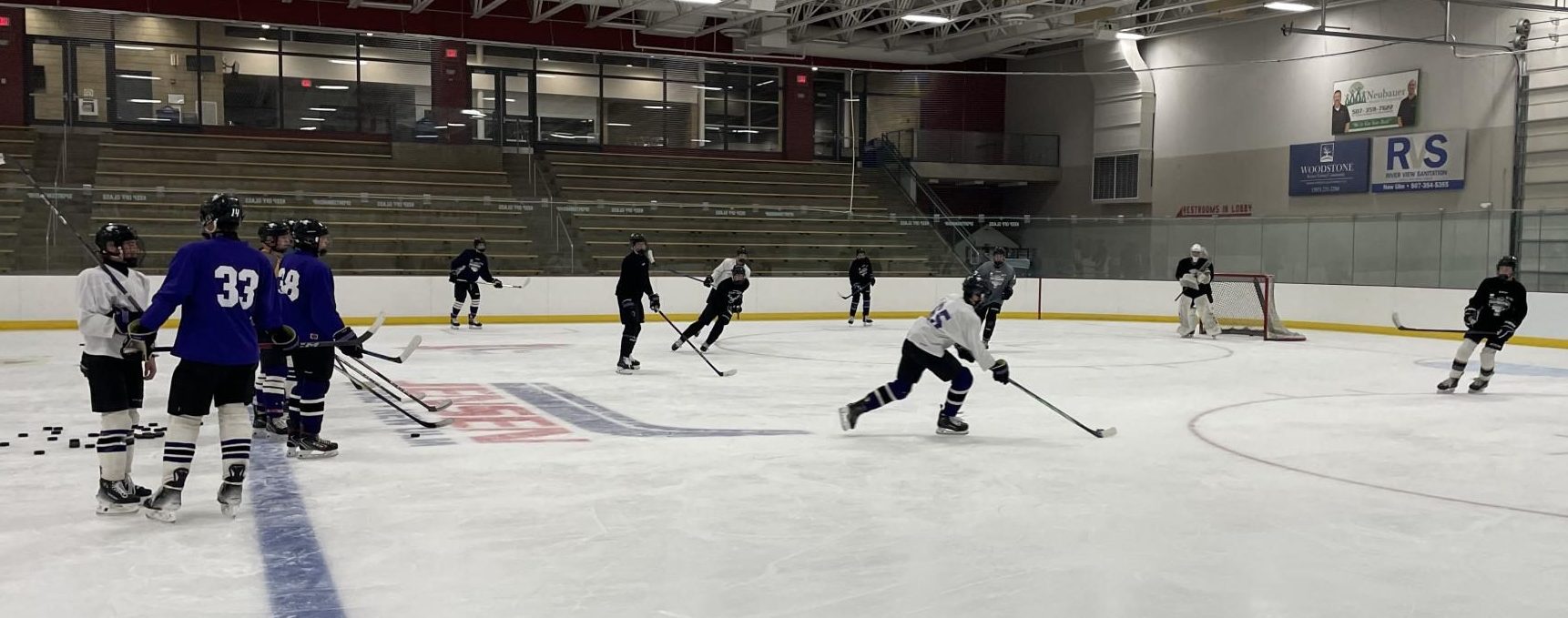 Jaxon Buegler begins to shoot puck in four vs two drill