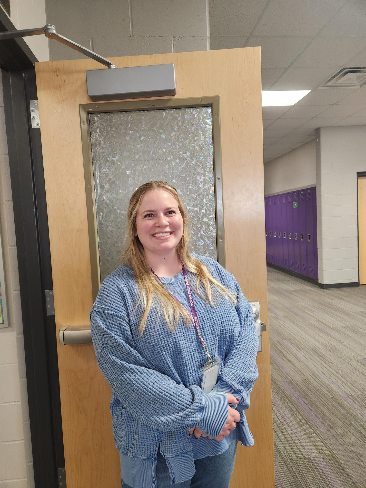 New social studies teacher and knowlege bowl coach Ms. Novacek is all smiles outside her classroom.