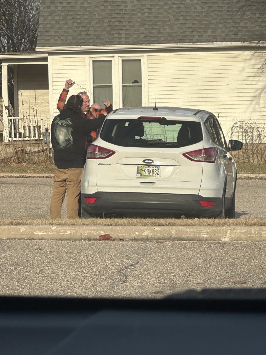 Teachers Jeff Nelson and Skyler Dustin opening the car up 