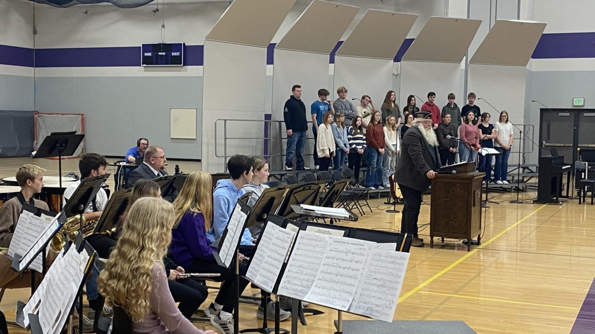 Veteran's Day 2024 Master of Ceremonies Commander Mike Finstad addressing the audience at NUHS.