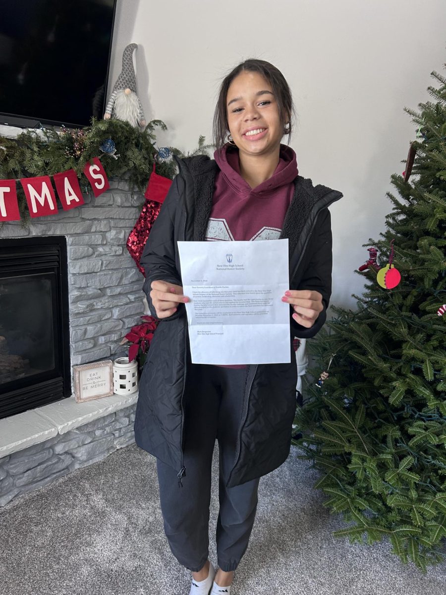 Junior KayLee Evans poses with her acceptance letter from National Honor Society.