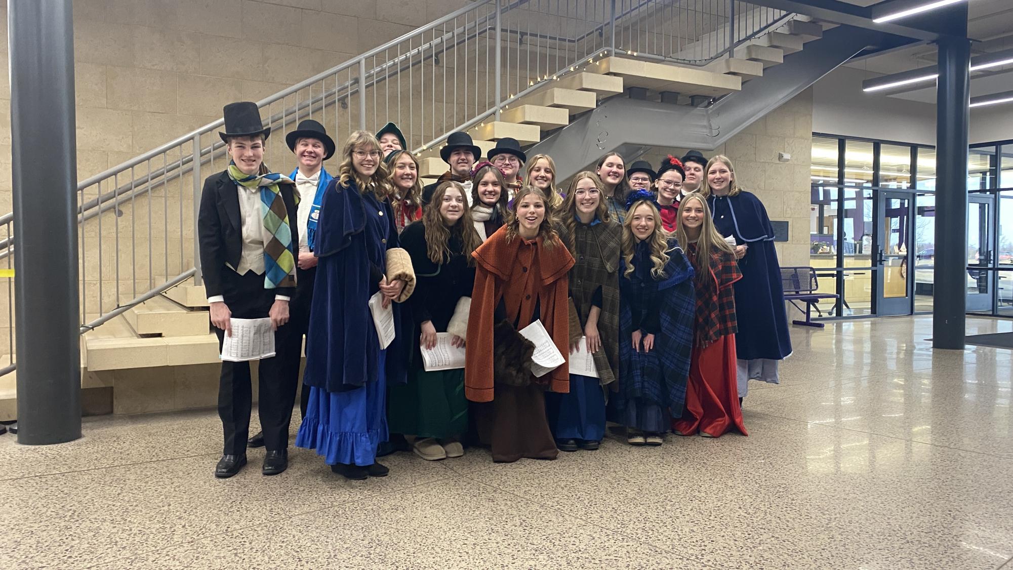 The Oak Street Singers pose for a quick pic before caroling through the halls of NUHS.