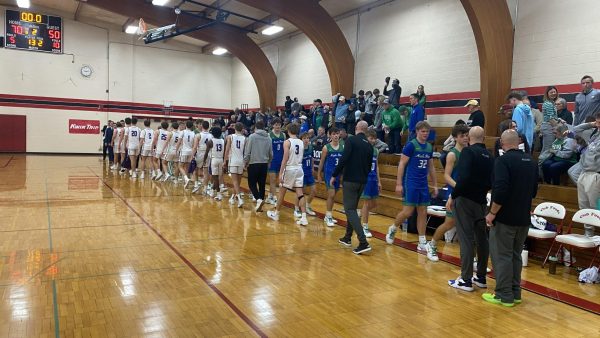 The Eagle's basketball team shakes hands with Maple River after a 1st round loss in the Kwik Trip Holiday Tournament at Bethany Lutheran College. The Eagles won the tourney here last year, and ended up getting 7th place in this year's event. 