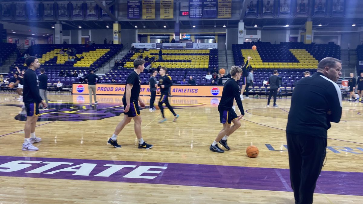 Former Eagle basketball standout Colton Benson, left, now a freshman on the Mankato State Basketball team, going through a pregame warmup before taking on St. Cloud State January 18.