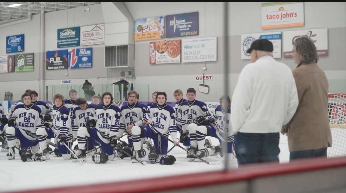 Boys Varsity team watching Tom Macho Present the Tom Macho award during the 1 period intermission.  