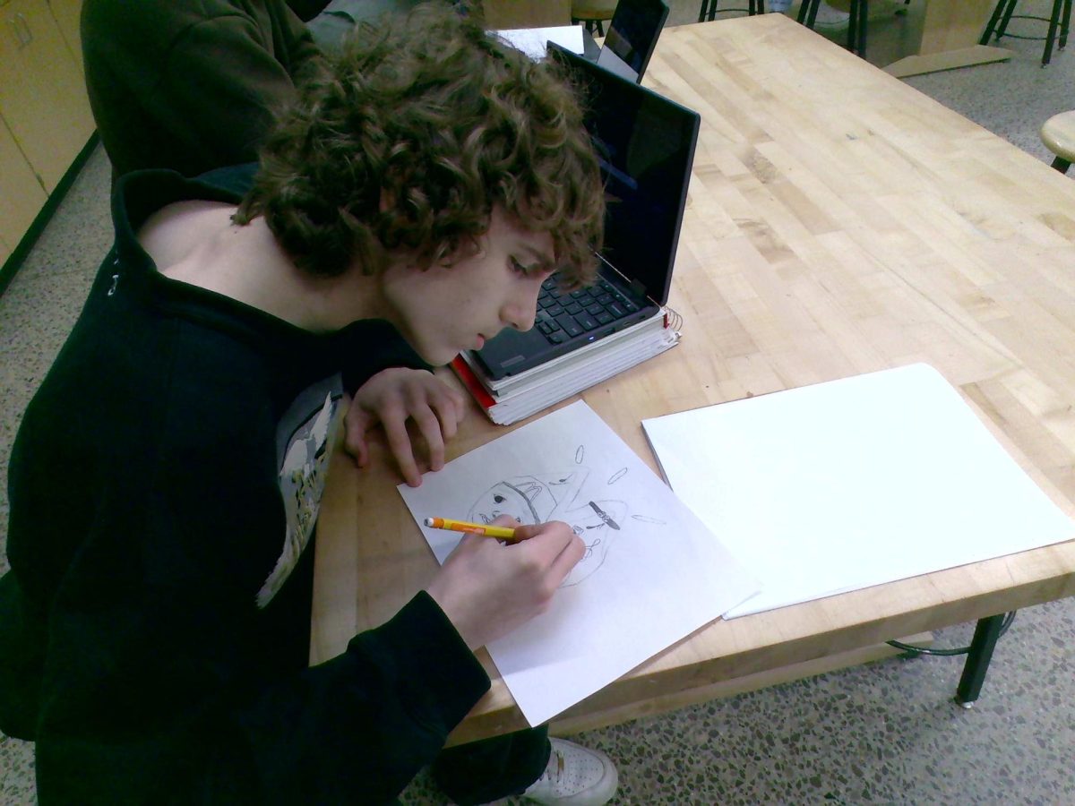 Aidan RockVam letting his imagination take flight drawing in art foundations. 