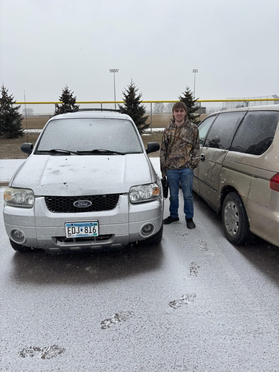 Gabe smiles as he proudly shows off his car.