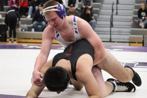 Cole Voges attempts to keep down his Martin County West opponent during his varsity debut.