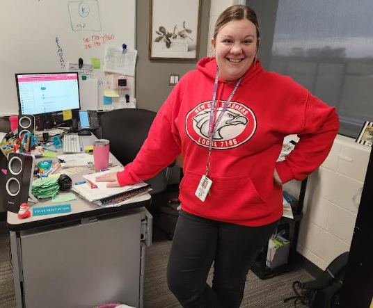 Mrs. Marlow stands next to her desk where she does a lot of planning and organizing. 