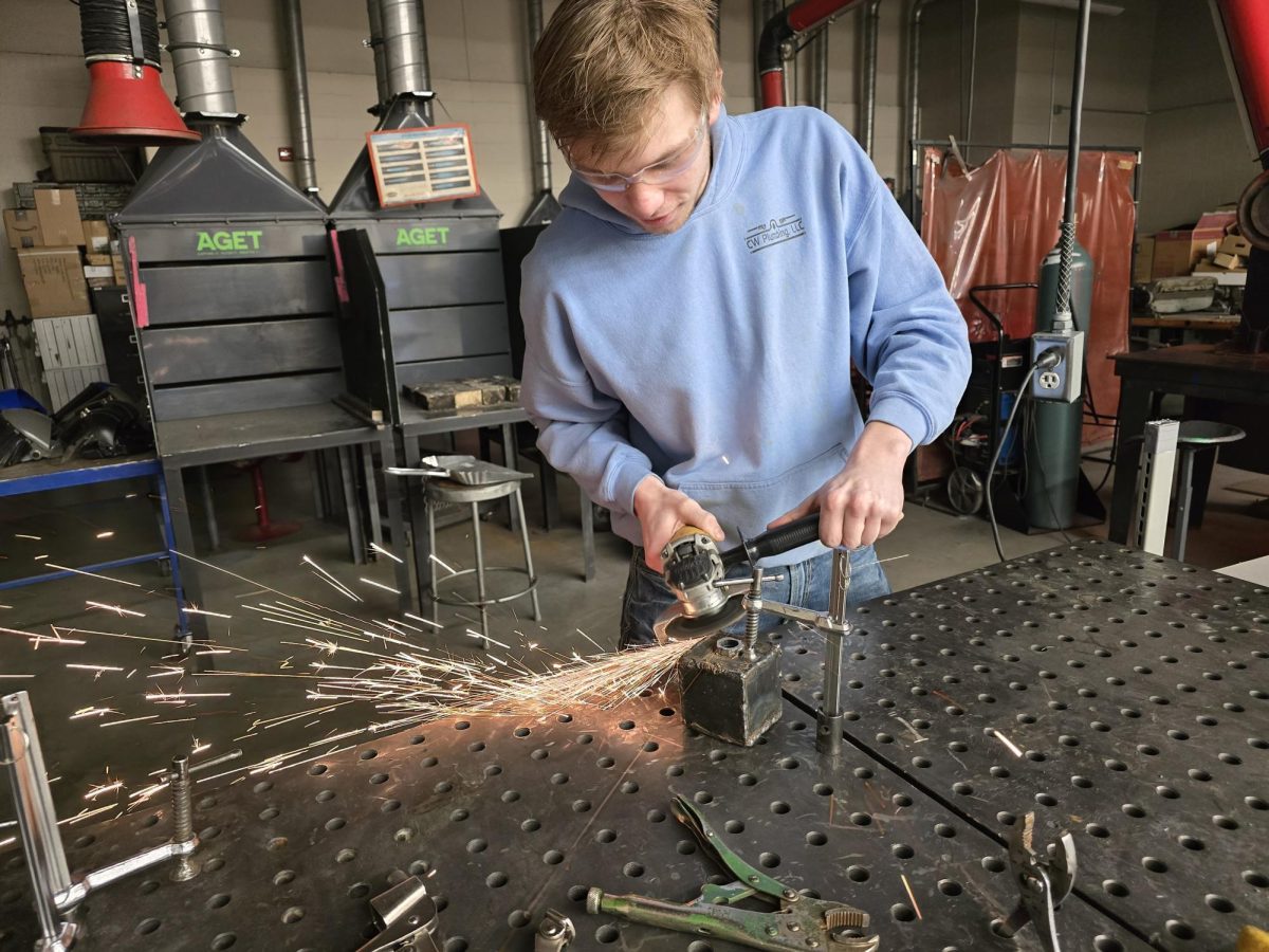 Cody Serbs operating an angle grinder