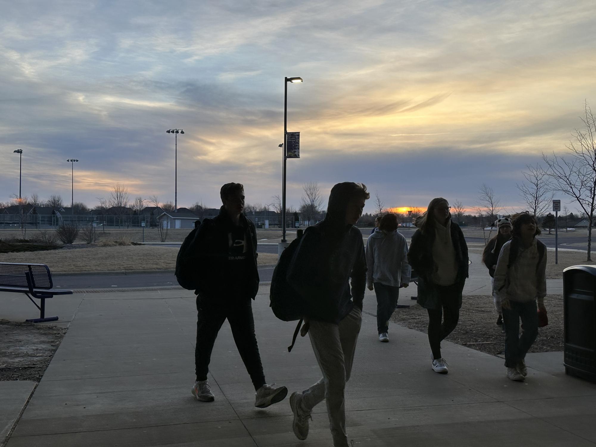 Students brave the freezing cold morning as they make their way into New Ulm High School, framed by a beautiful sunrise on a bitter winter day.