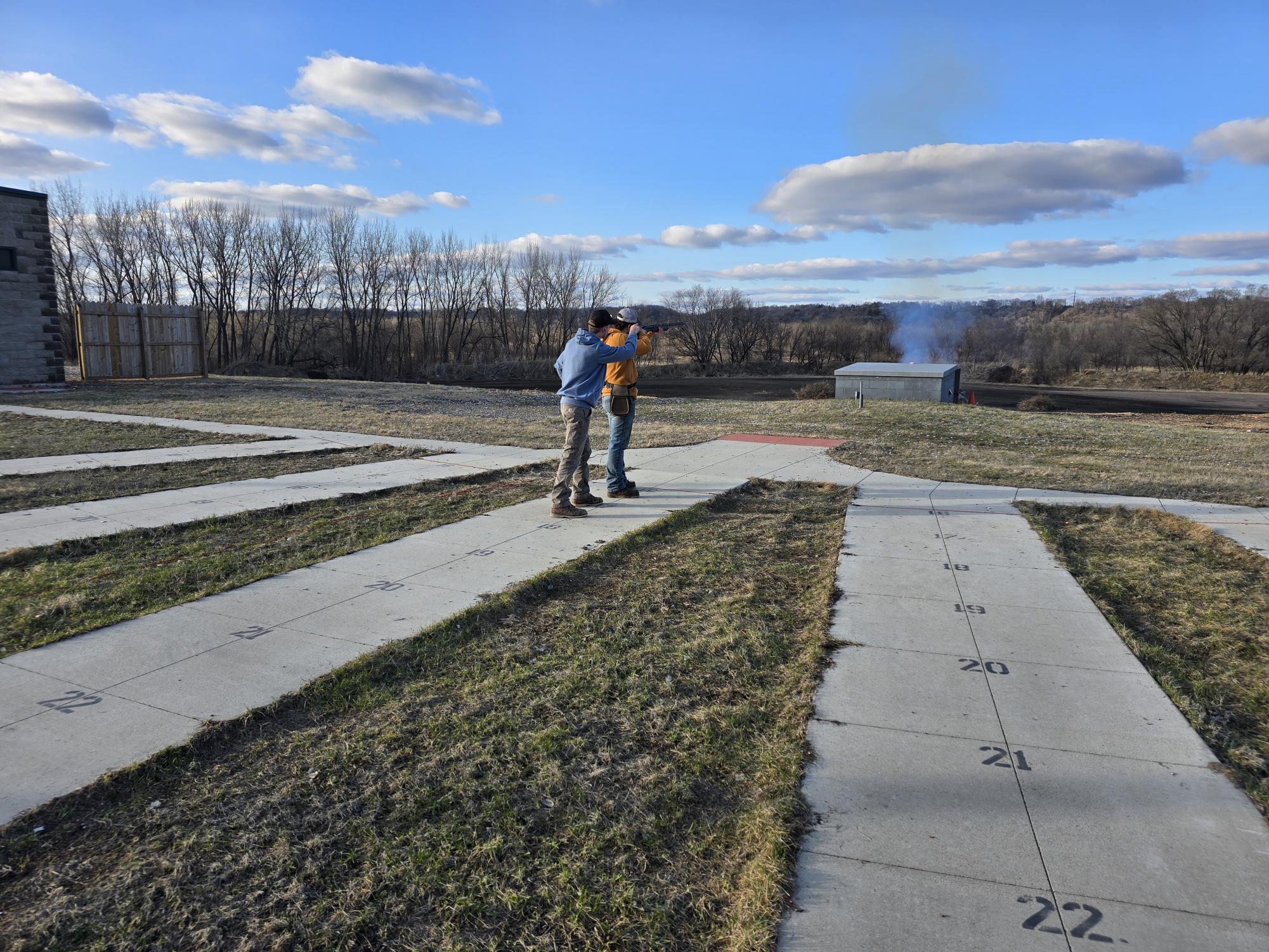 Landon Beck( on the left) coaching Casey Koop at the New Ulm trap range on Monday evening