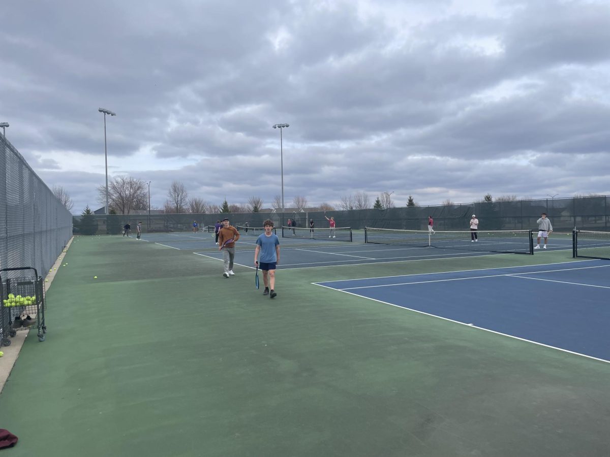 Boys tennis players working hard at practice.
