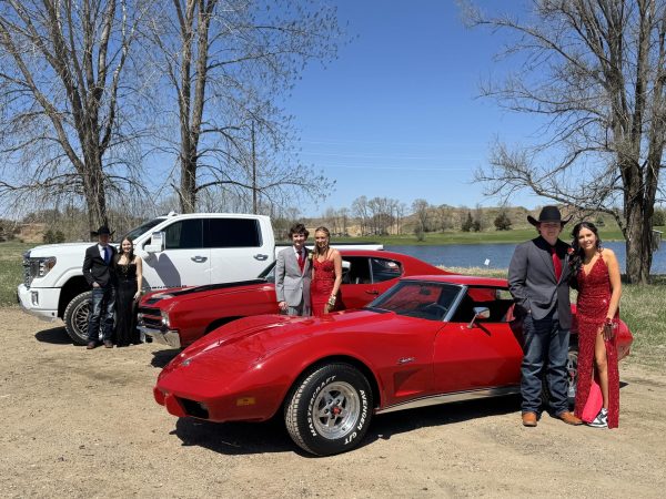 (L-R) Jace Hinderman and Ava Nachreiner, Masyn Hauser and Makena Meier, and Andrew Hellendrung and Halle Hinderman show off their stylish rides and formal outfits before heading to prom. The group posed with a GMC Denali truck, a classic Chevrolet Chevelle, and a Corvette Stingray.