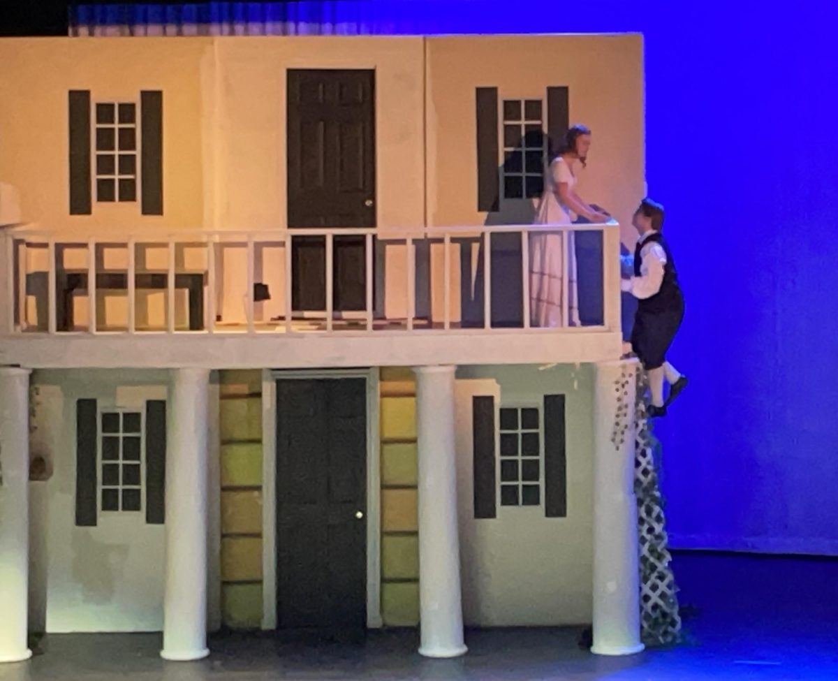 Senior Henry Waloch, Romeo, scales the trellis to Juliet, Senior Josie Stade.