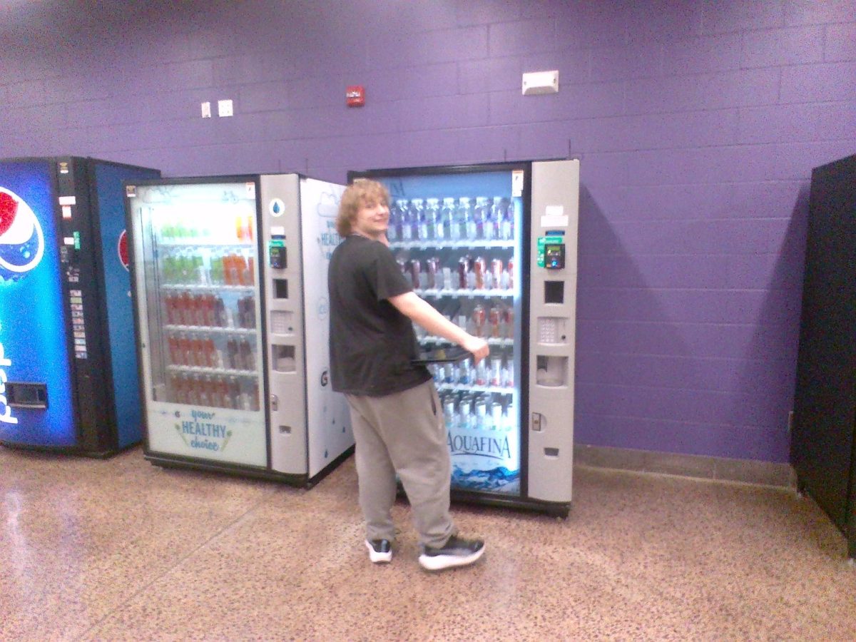 Senior Sylas Hacker getting a drink from the vending machine