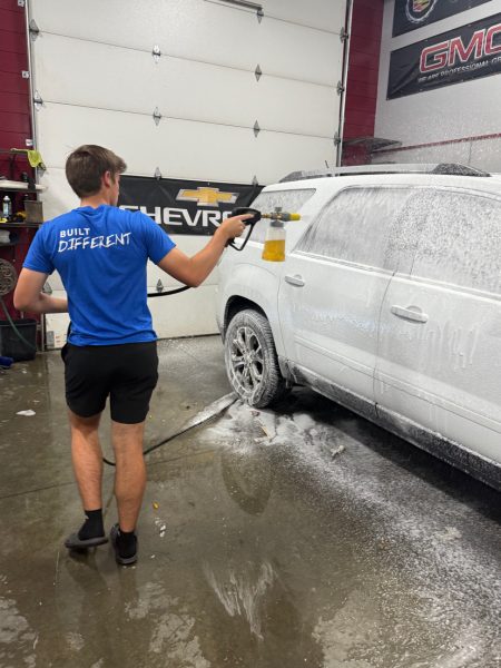 Brayden Wendinger spraying a car with soap