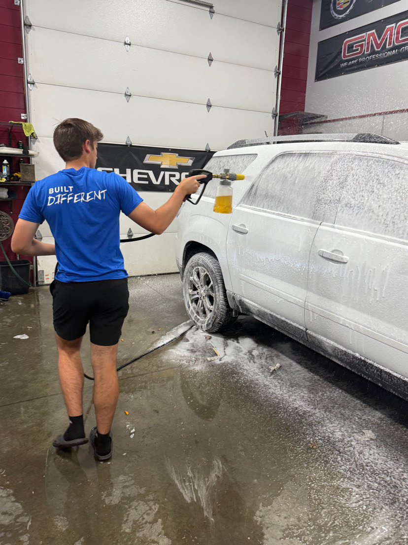Brayden Wendinger spraying a car with soap