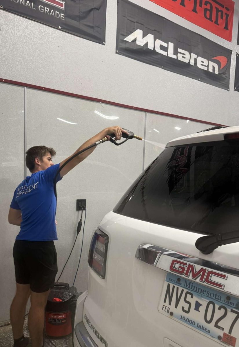 Brayden Wendinger sprays car with water
