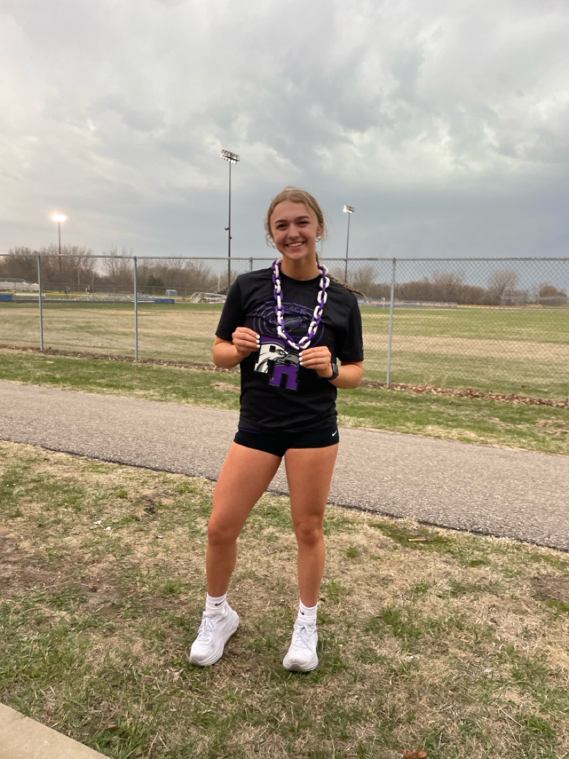 Junior, Isabelle Longtin posing for a photo after achieving a personal record in track and field.