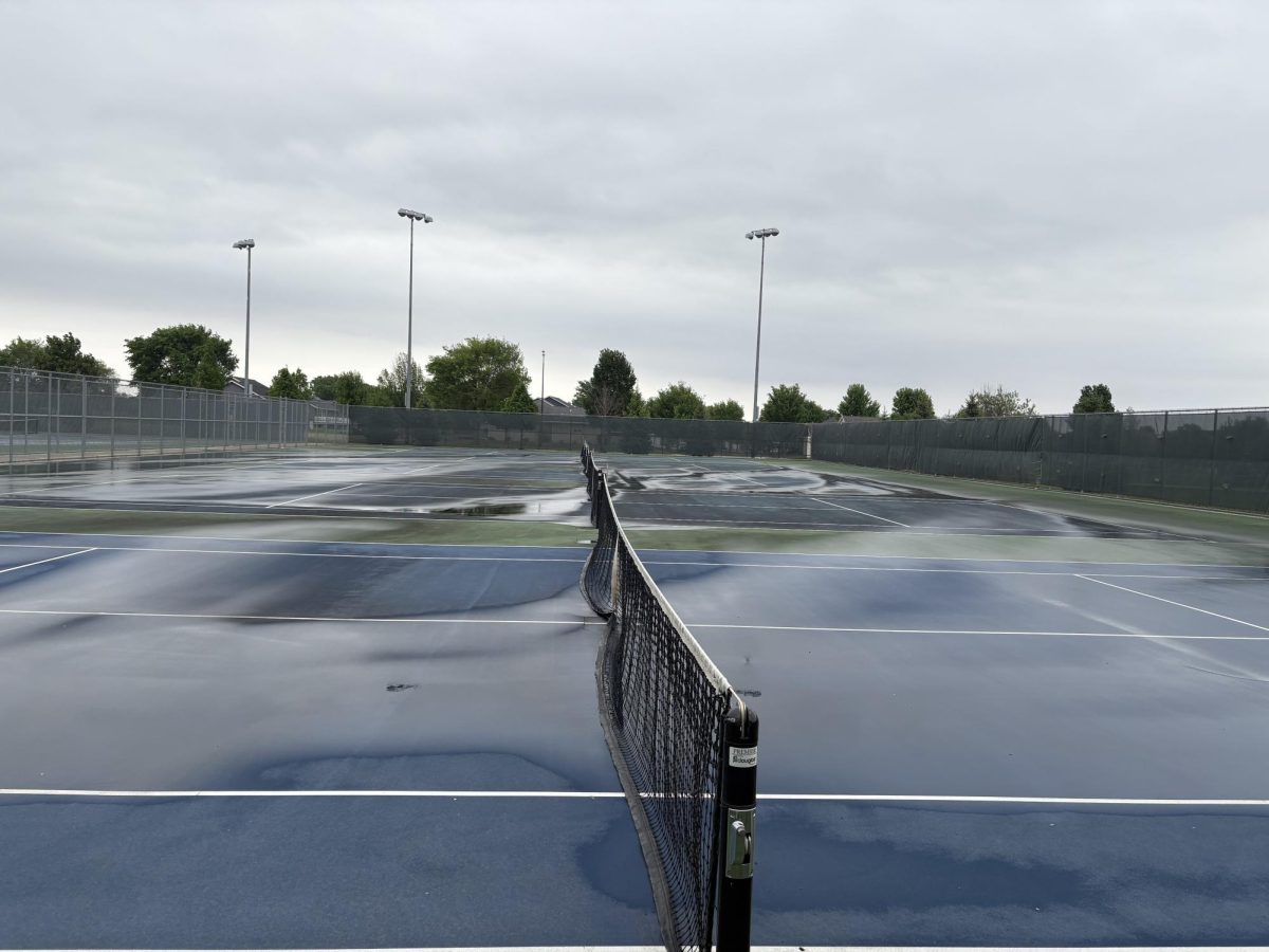 Tennis courts all puddled up. 