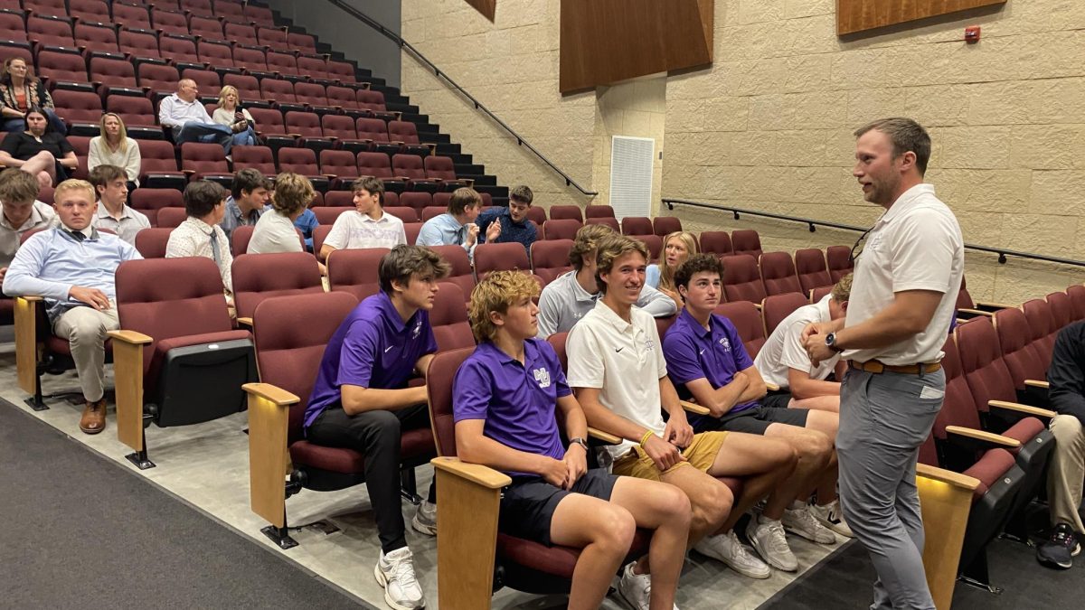 Golf coach Mr. Aukes firing his troops up before the start of the Annual Booster Banquet.