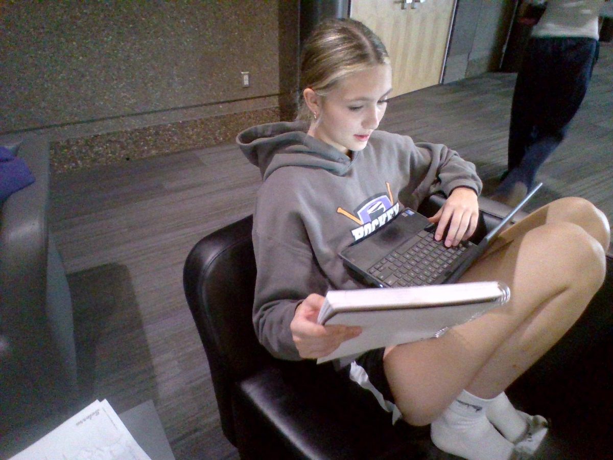 Freshman Leah Brustad learning new material in the upper commons.  